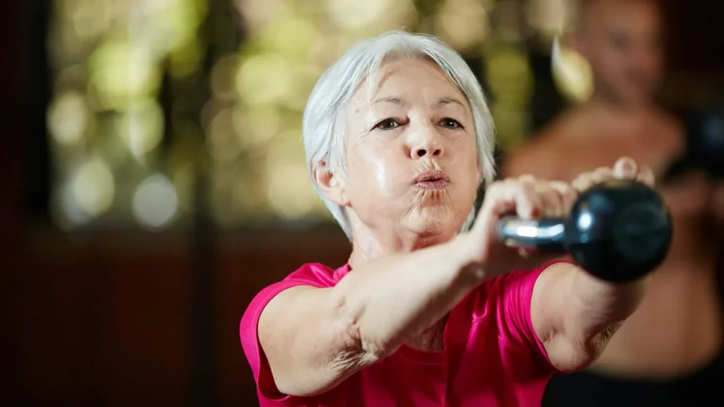 Toning Arms Without the Bulk: Is It Achievable? 1 Woman doing resistance band exercises for toned arms Falkirk